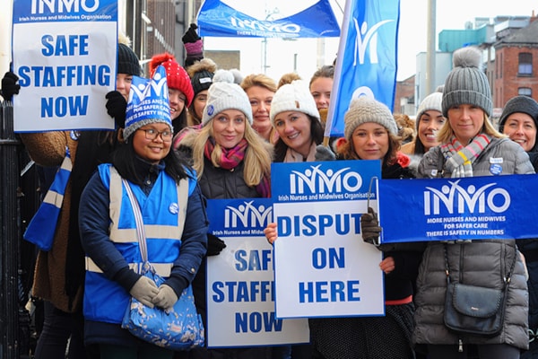 a group of nurses holding signs saying 'Dispute On Here'